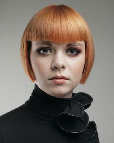 Short reddish blonde under the ears bob haircut with bangs 