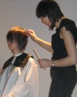 Scissor cutting the sides of a bob