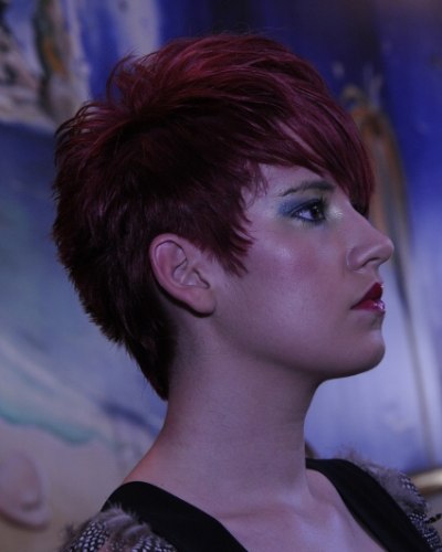 Short haircut with a cut out ear, gradated neckline and longer hair on top