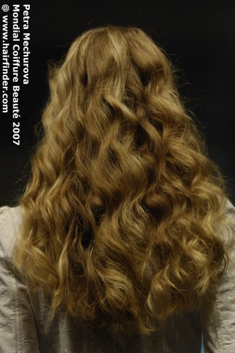 Back view of long mid-back hair with large waves