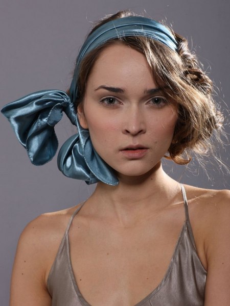 Shiny silk scarf wrapped around the head