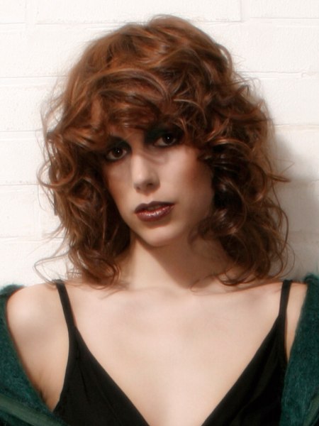 Long 1980s hairstyle with curls and thick bangs