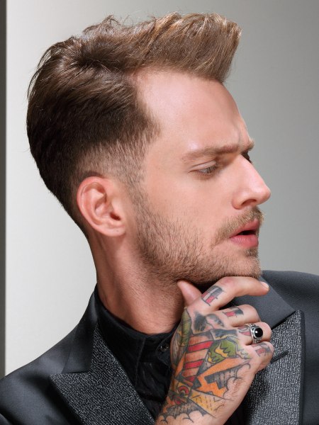 Short men's hairstyle with a quiff and undercut