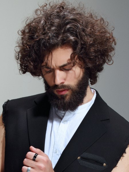 Men's look with long curly hair and a beard