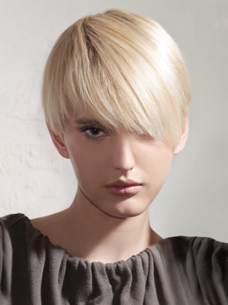 Modern short haircut that is a cross between a pixie and a bowl cut