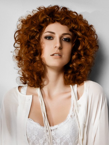 Shoulder length red hair with large curls