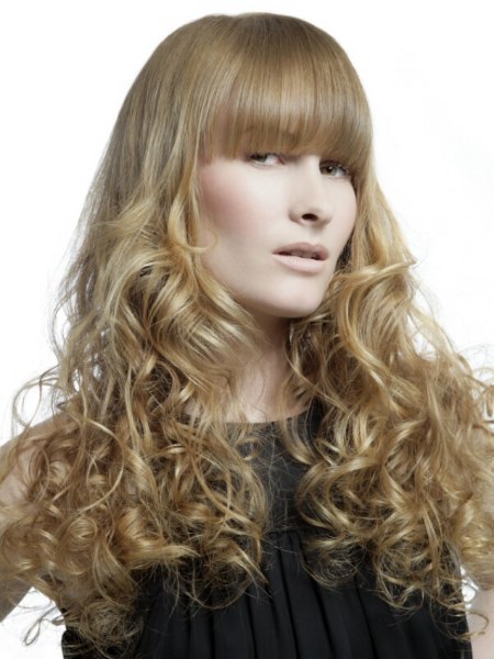 Long hairstyle with blonde spirals and bangs that are half way over the eyes