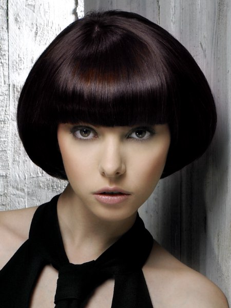 Chin-length bob styled glassy smooth and curving inward