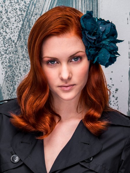 Long red hair with sleek waves and a blue flower