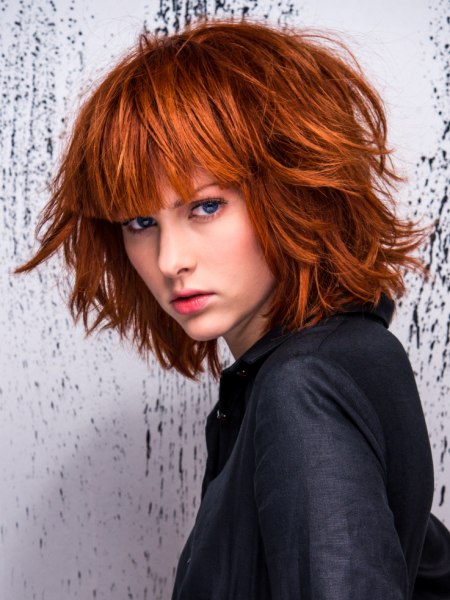 Red hair in a mid-length bob with a long, straight fringe