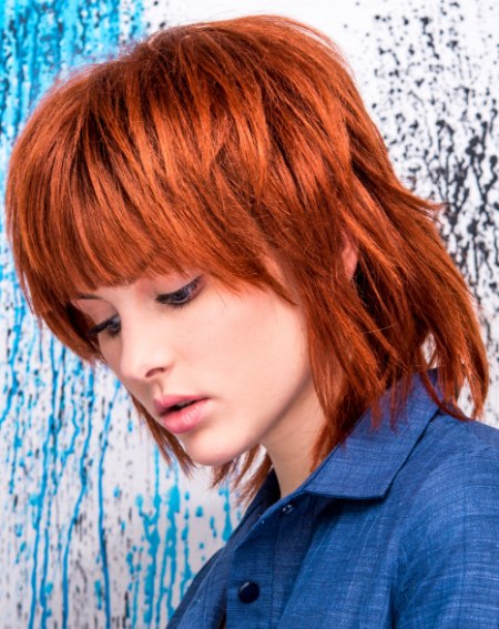 Red hair bob cut with jagged cutting lines