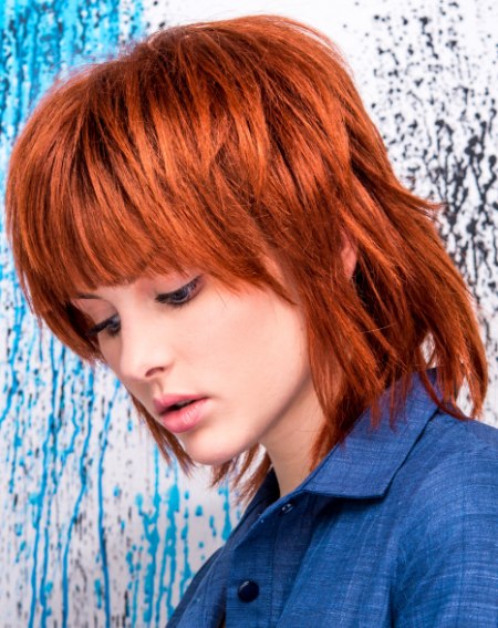 Red hair bob cut with jagged cutting linesr