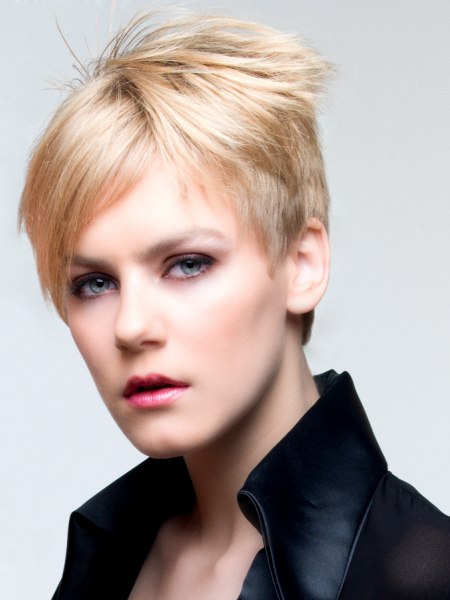 Short blonde pixie cut hair with a hint of pink