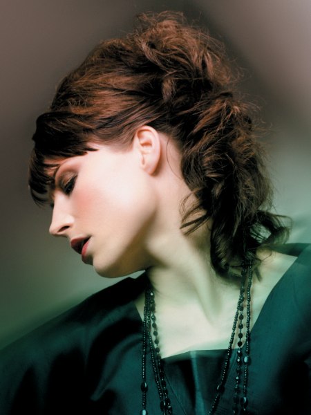 Warm brunette hair styled in an assemble of curls