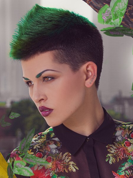 Very short clipper cut hair with a combination of black and green colors