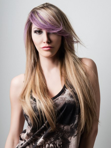 Blonde hair with a purple streak in the fringe