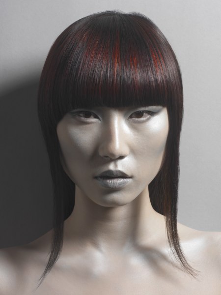 Medium long red hair with slices of black and a blunt fringe