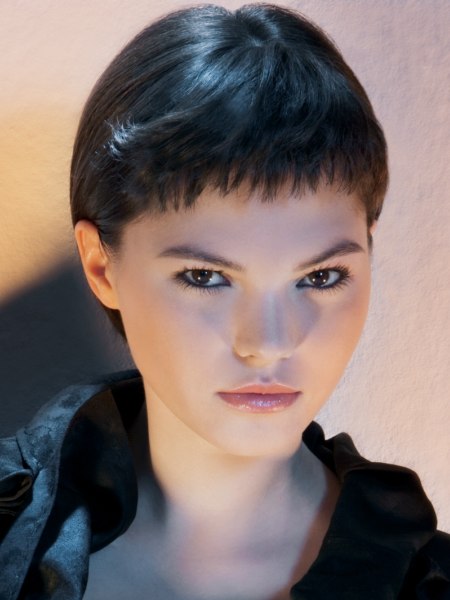 Short haircut with a curved cutting line and a short fringe