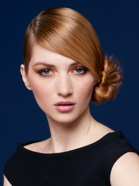 Updo with the hair rolled up into a chignon on the side