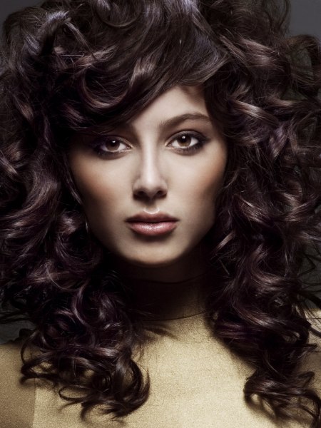 Long voluminous hairstyle with satiny curls