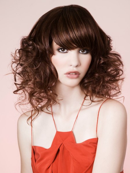 Long-layered haircut with curls and a deep blunt cut fringe