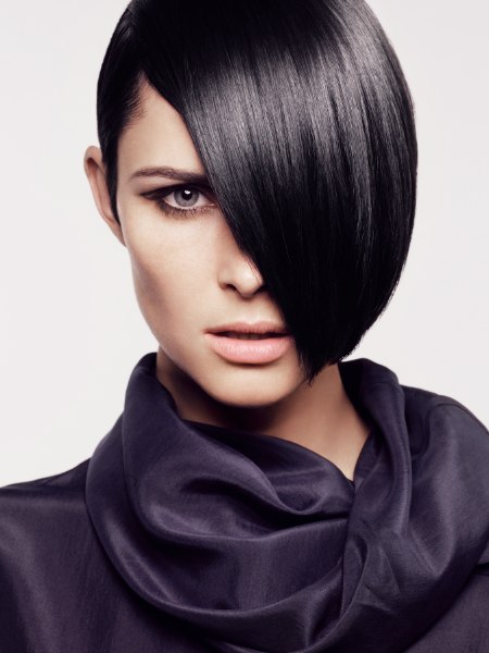 Chin length bob haircut with one side tucked behind the ear