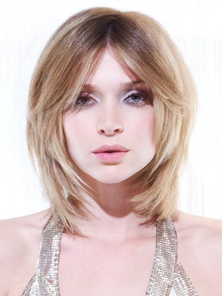 Medium-length haircut with a round form and blonde shades