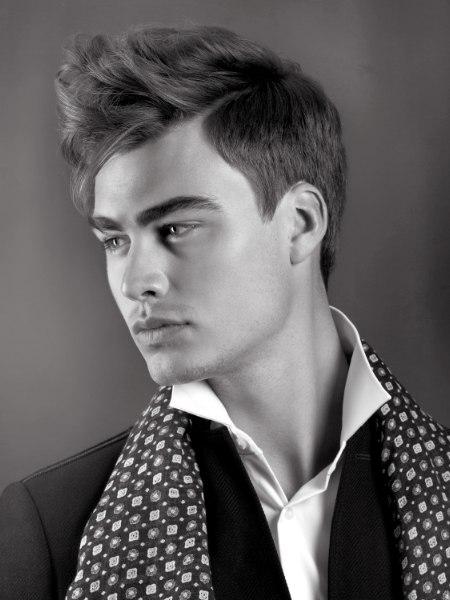 Romantic men's hairstyle with short clipped sides  and bangs