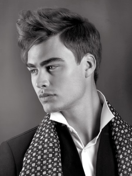 Romantic men's hairstyle with short clipped sides and bangs