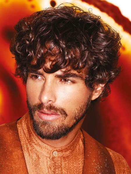 Mens hair style with short curls and a beard
