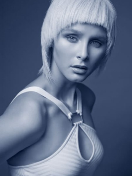 Short blonde hair with a curved cutting line