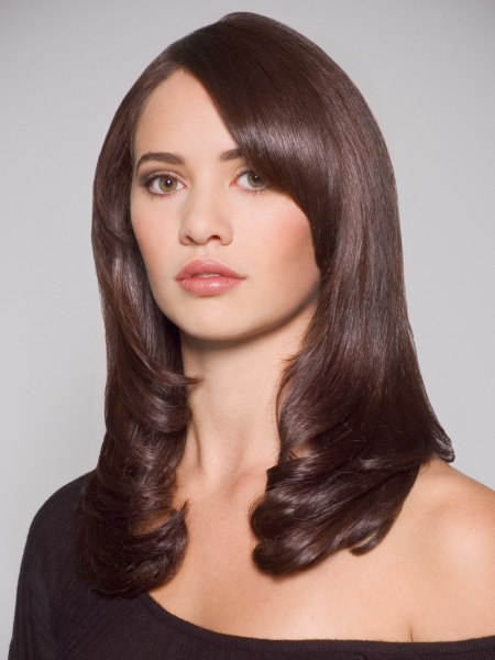 Classic angled-layer cut on long hair that frames the face