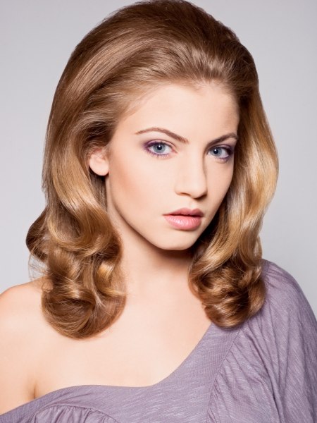 1960s inspired hairstyle with long flowing waves that curl up at the ends