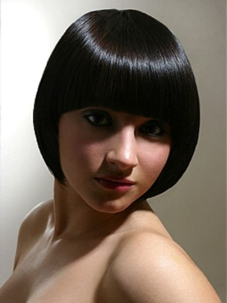 Super sleek bob haircut with a fringe that follows the brow line