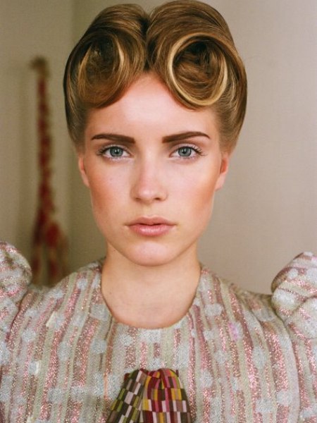 French retro pinned hairstyle with the hair combed upward and rolled