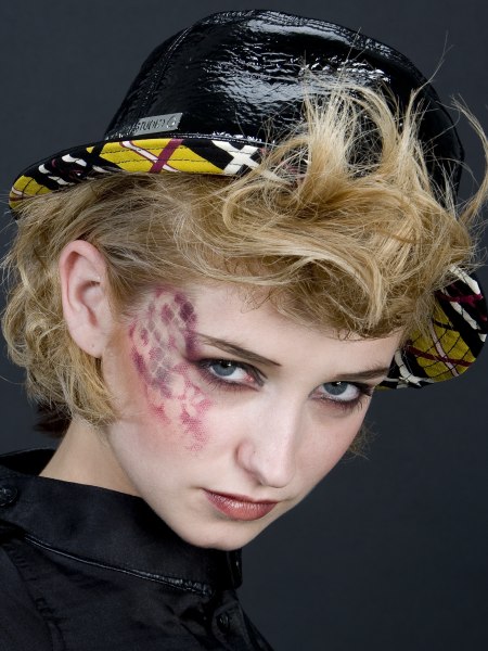 Hair taken to the back and paired with a hat