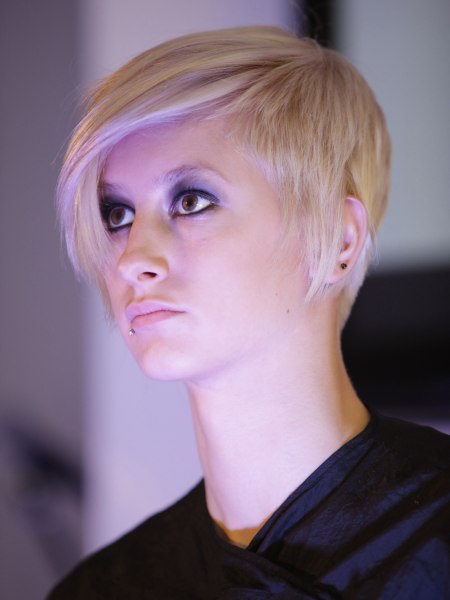 Blonde pixie cut with a curved fringe