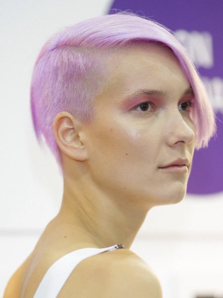 Very short haircut with a lavender hair color
