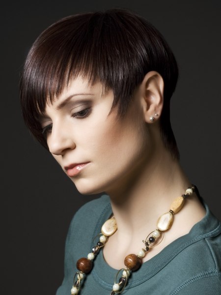 Pixie style haircut with tapered sides and a curved fringe