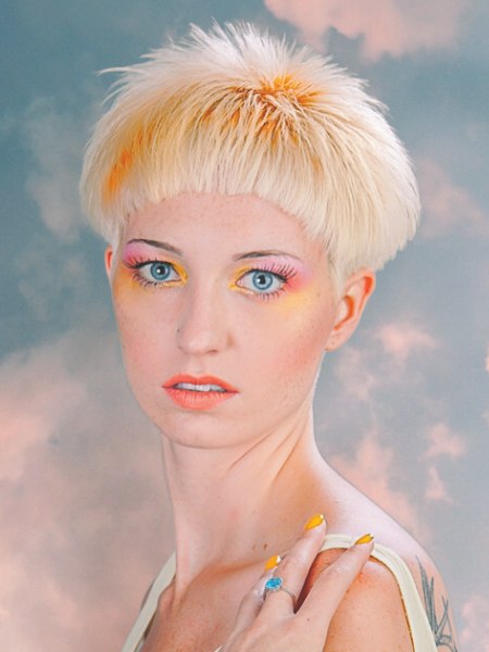 Short blonde hair with orange accents, elevated above the ears