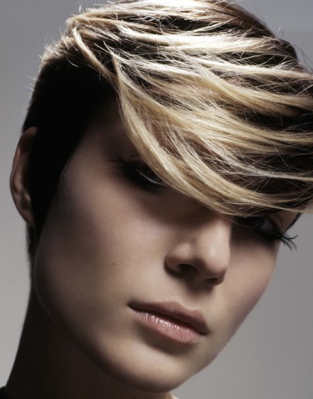Very short haircut with blonde over black hair coloring