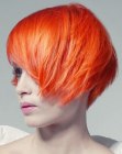 Extravagant hairstyle with a lava red hair color