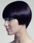 Short black hair with precise cutting lines and a round silhouette