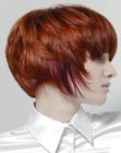 Red hair cut to a short face framing hairstyle with bangs