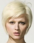 Short platinum blonde hair with a crown section that poufs up