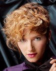Short feminine hairstyle with varying lengths and curly bangs