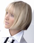 Smooth blonde bob with horizontal bangs and a clean weight-line
