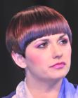 Sleek short hairstyle with layered sides and a shiny surface