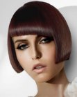 Short French bob cut with diagonal bangs and smooth styling