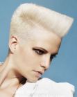 Short blonde hair shaped to a wedge for a Grace Jones look